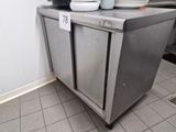 a stainless steel cabinet with plates on top of it