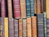 a box full of old books sitting on the floor
