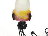 a lamp that is sitting on a stand on a white surface