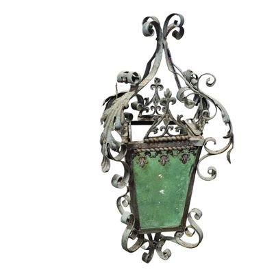 an image of a green glass hanging light fixture on a white wall