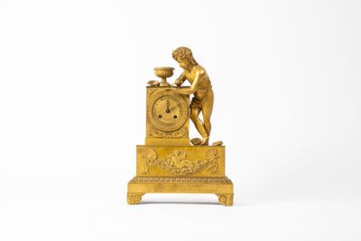 an image of a gold clock sitting on top of a table