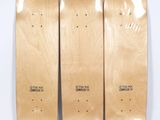 three skateboards sitting side by side on a white surface