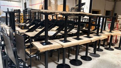 many chairs and tables in a room with a lot of them