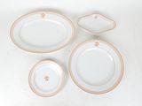 four plates and a bowl on a white table