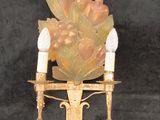 a candle holder with two birds on it on a black background