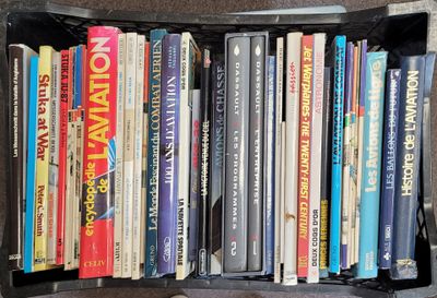 many books in a black box on the floor