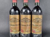 three bottles of wine sitting on top of a table next to each other