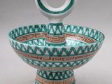 an image of a green and white bowl sitting on top of a table