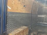an image of a van with a wooden bench in the back