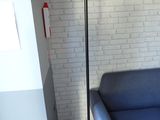 a blue couch and a black floor lamp in a living room
