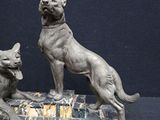 statue of a dog and a cat sitting on a marble base