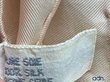 a close up of a person ' s hand holding a piece of fabric