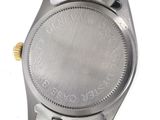 a close up of a watch on a white surface with a white background