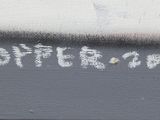 a graffiti on the side of a building with writing on it