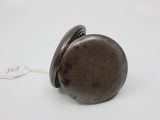 a small metal object that is sitting on a white surface