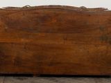 an old wooden suitcase sitting on a wooden floor