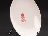 an image of a white plate with a red design on it