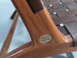close up of a wooden chair with a button on the seat