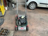 a lawn mower that is parked in a garage