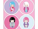 four japanese dolls in pink, purple, and blue on a pink background
