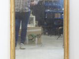 a man standing in front of a mirror in a room