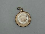 an antique photo of a woman in a white dress is shown on a gold plated pendant