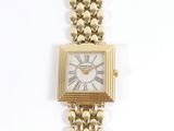 une image d'un gros plan d'une montre-bracelet sur une surface blanche