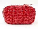 the red clutch bag is made out of woven fabric and has a metal clasp