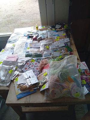 many bags of food sitting on a table in front of a window