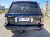 a black range rover parked in a parking lot