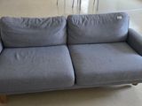 a blue couch that is sitting in a room