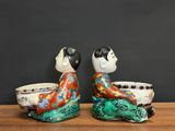 pair of asian figurines of a man and a woman sitting on a table