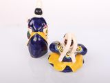 two salt and pepper shakers sitting next to each other