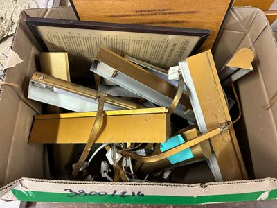 a cardboard box full of books and other items