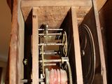 a wooden box with a clock inside of it