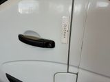 a close up of a door handle on a white car