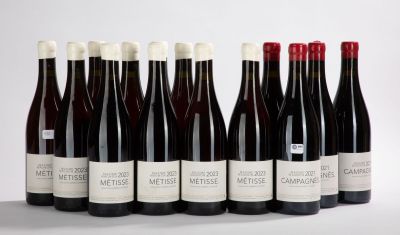 six bottles of red wine lined up in a row on a white surface