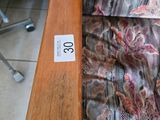 a close up of a wooden bench with a price tag on it
