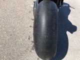 a close up of a motorcycle parked in a parking lot