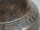 a large bronze bell with writing on it