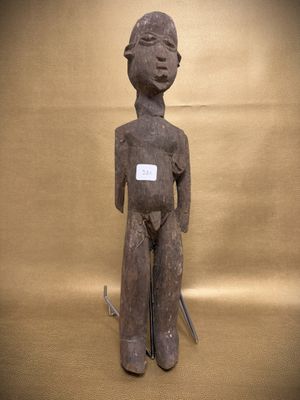 statue of a man holding a knife and a knife in his right hand