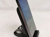 a close up of a cell phone on a stand on a table
