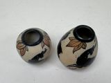 two vases that are sitting on a table