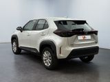 the rear end of a white toyota rav parked in a room