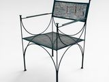 a green metal chair that is sitting on a white surface