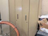 a large metal cabinet and a bike wheel in a garage