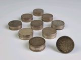 a pile of coins sitting on a table next to a coin