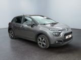 the grey citrole is parked in a room with a black floor