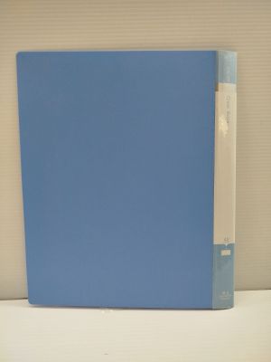 the blue book is sitting on a white table