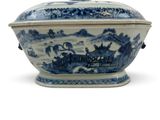 a blue and white bowl with a lid on a table